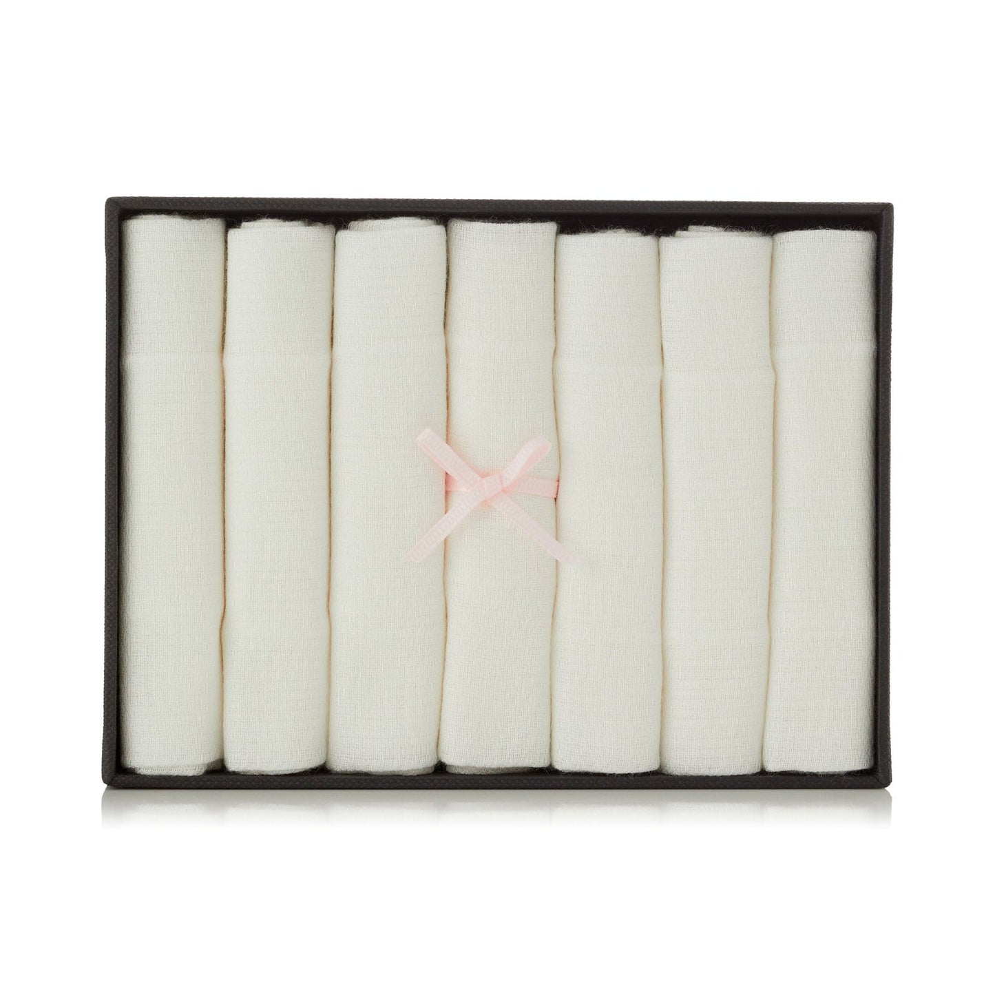 Set of white folded bamboo muslins in a black box with a pink ribbon on a white background