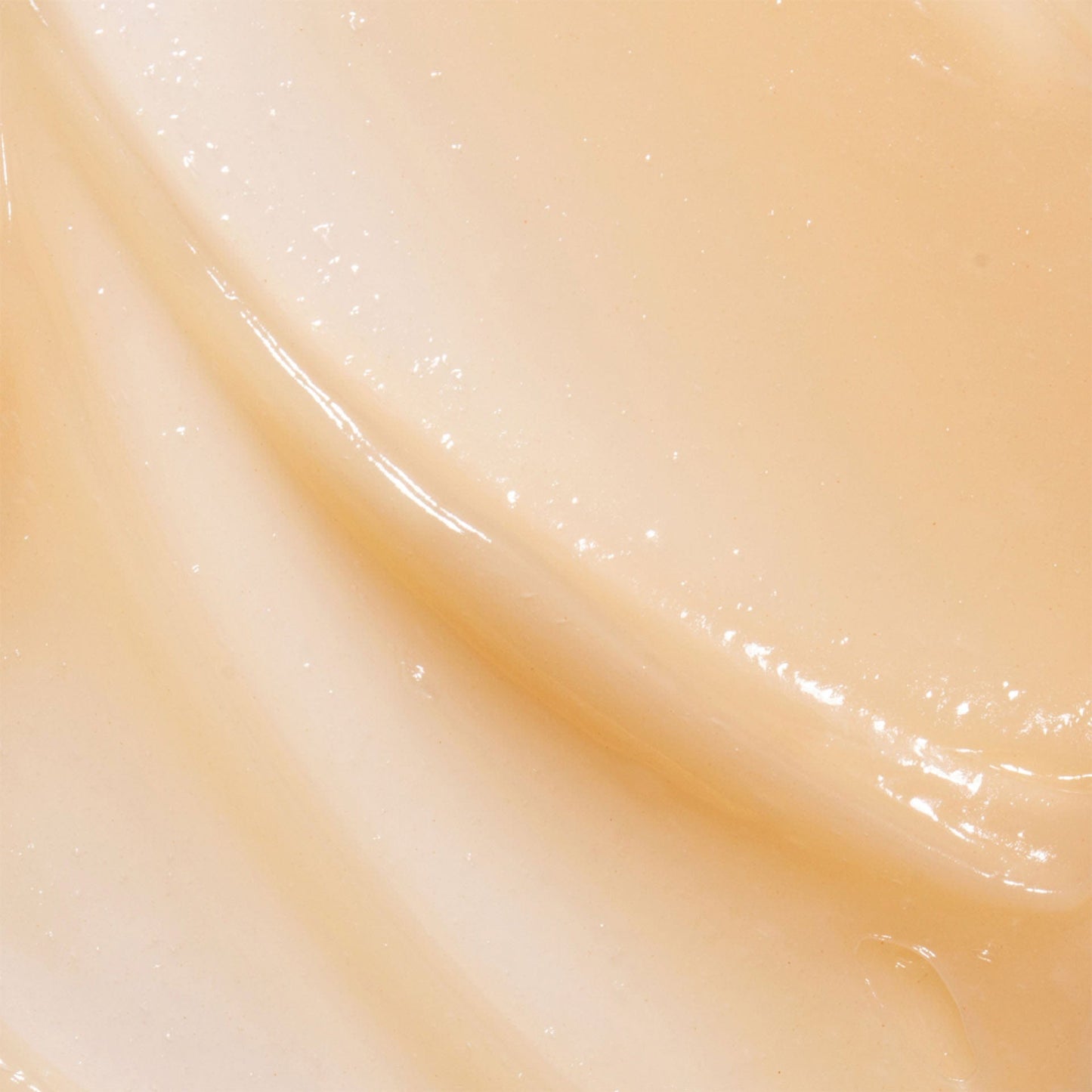 Close-up of a smooth, beige-colored brightening anti-pollution mask with a glossy finish.