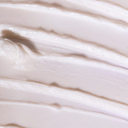 Close-up of smooth, beige cream with wavy patterns