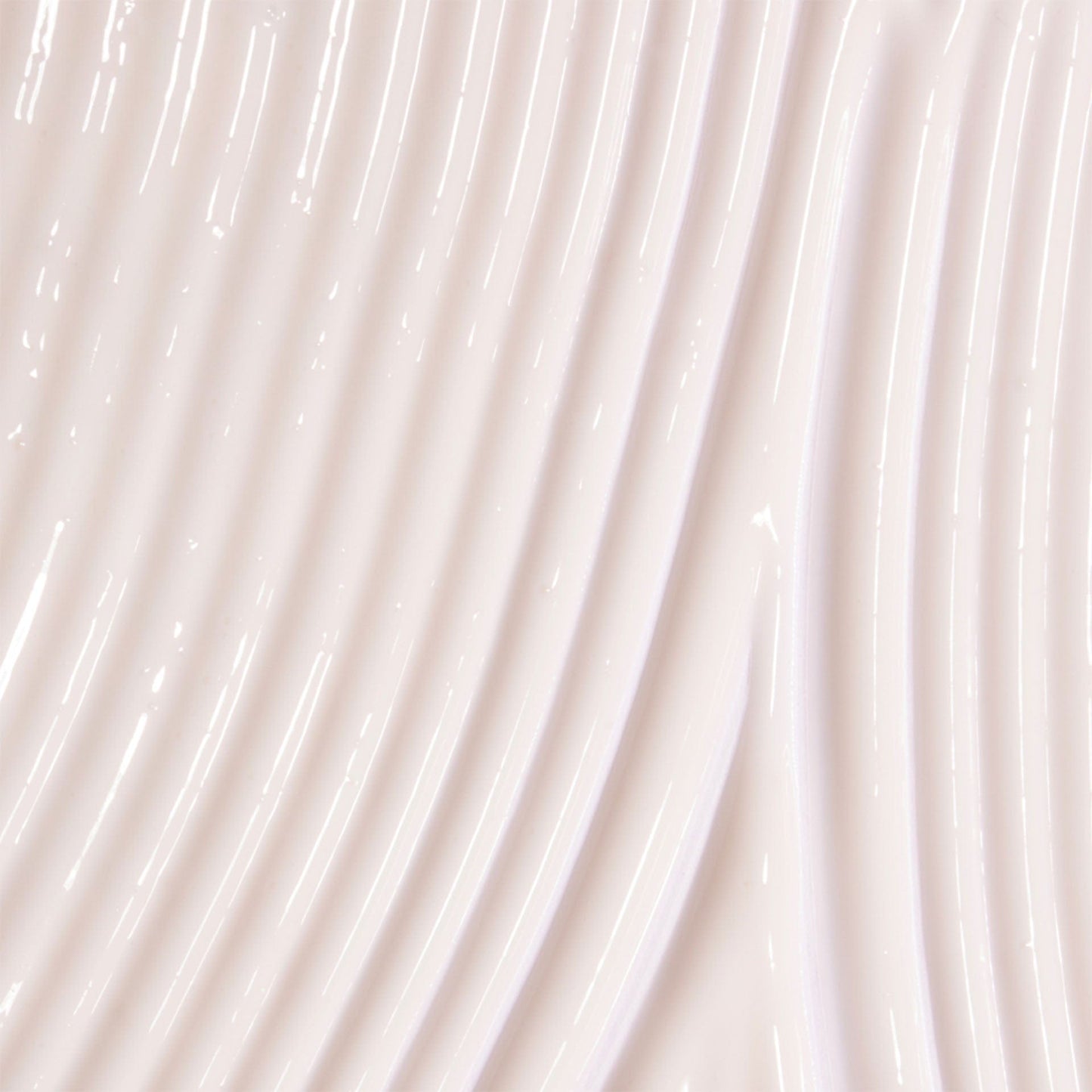 Close-up of beige body serum swatch with a subtle texture