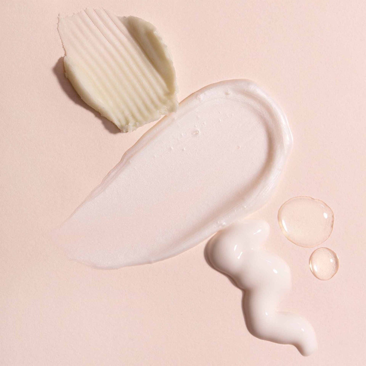 White skincare swatches on a pink background