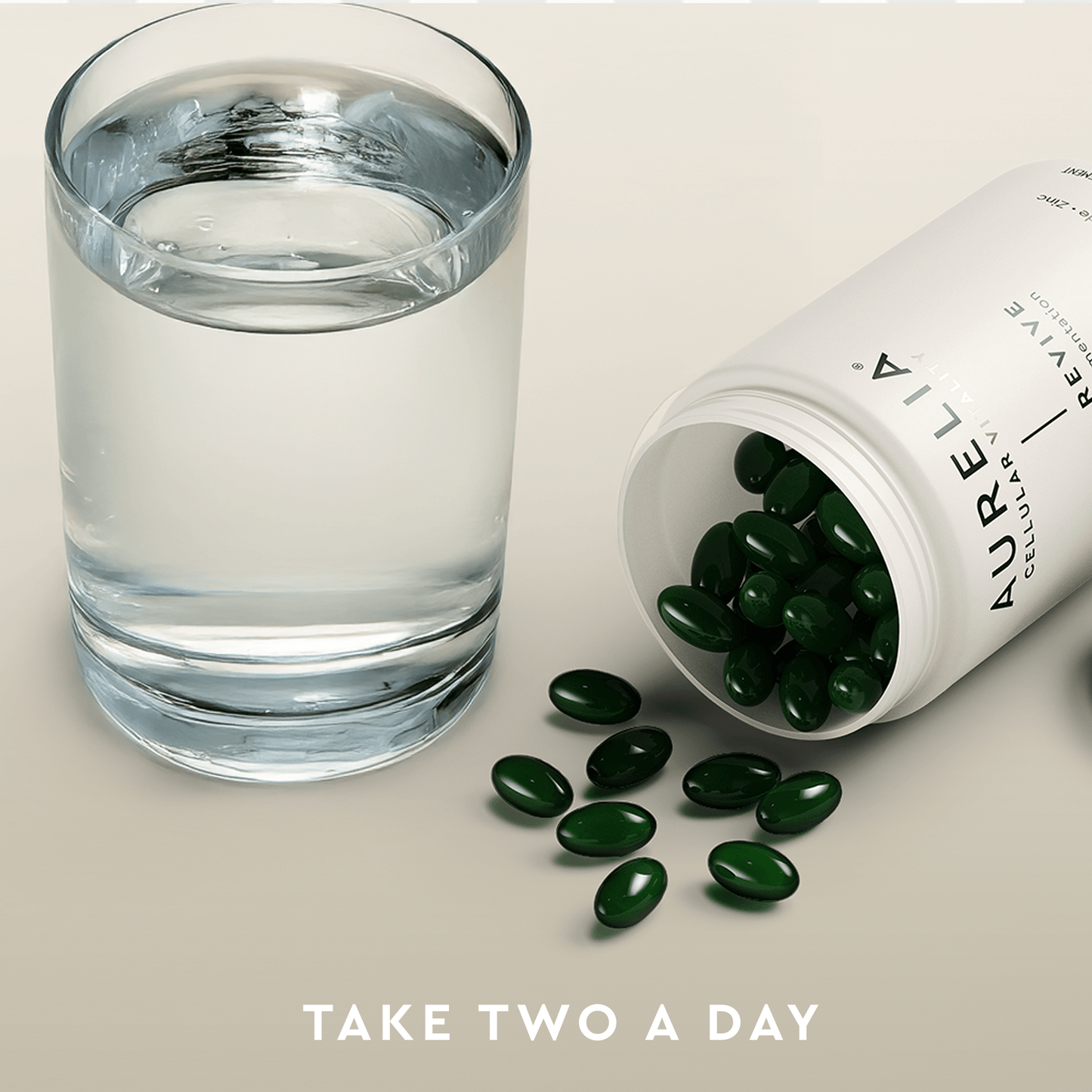 Glass of water next to an open bottle of Aurelia supplements with green capsules on a light background.