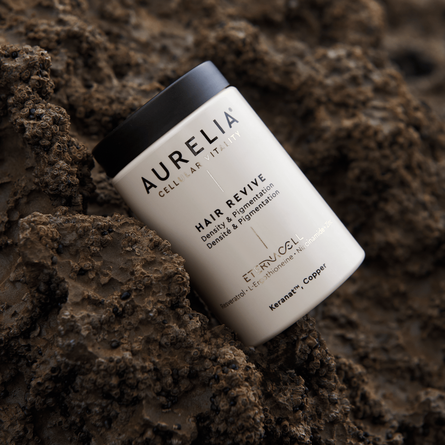 Aurelia hair revive product on a textured brown surface