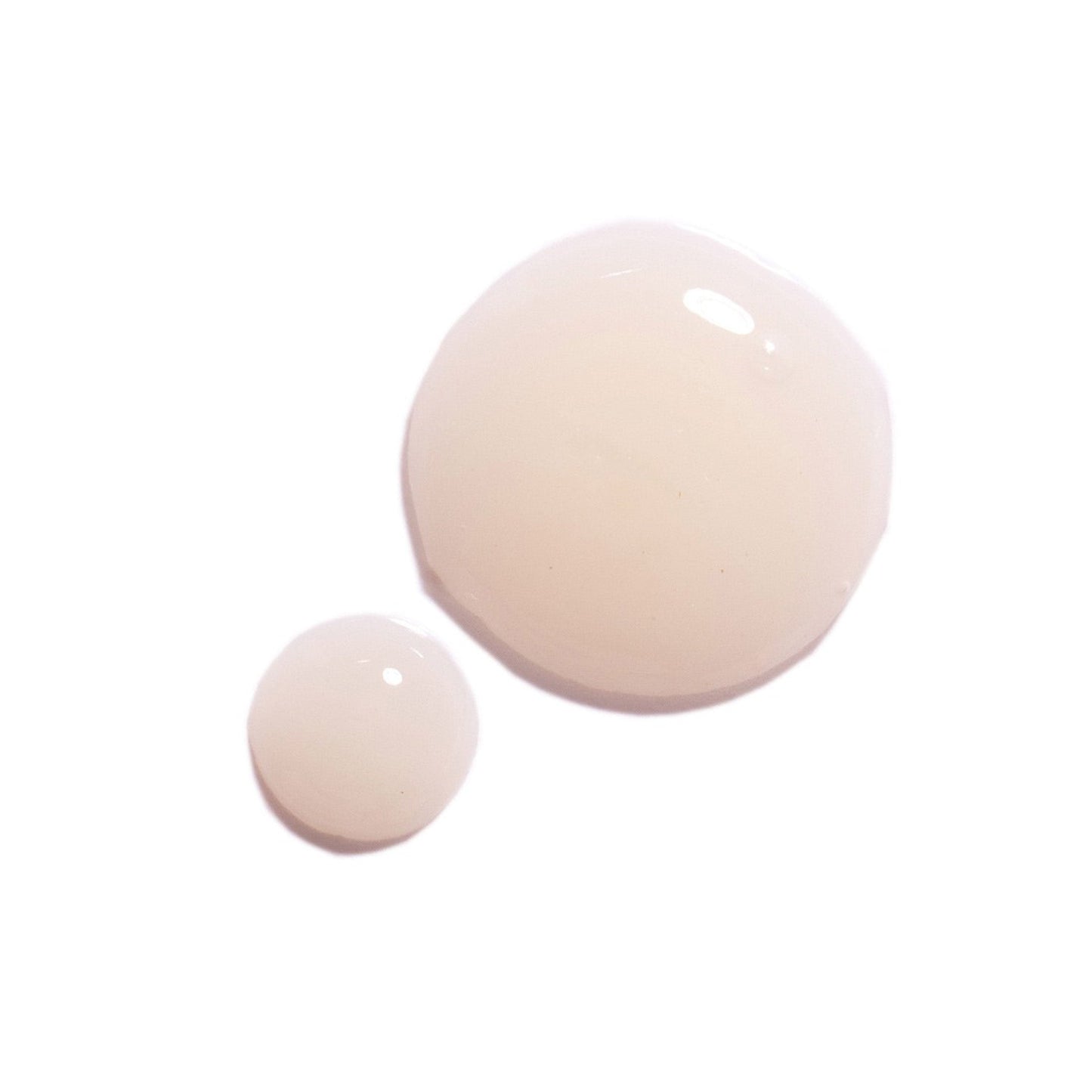 Two beige-colored round revitalise glow serum swatches on a white background