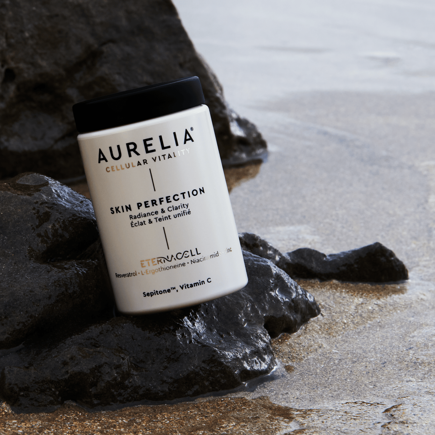 Aurelia skin perfection product on a rock by the water