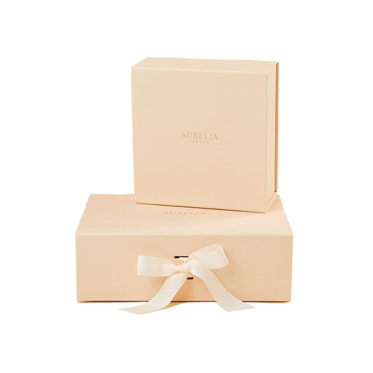 Beige gift box with a ribbon and 'Aurelia' branding on a white background
