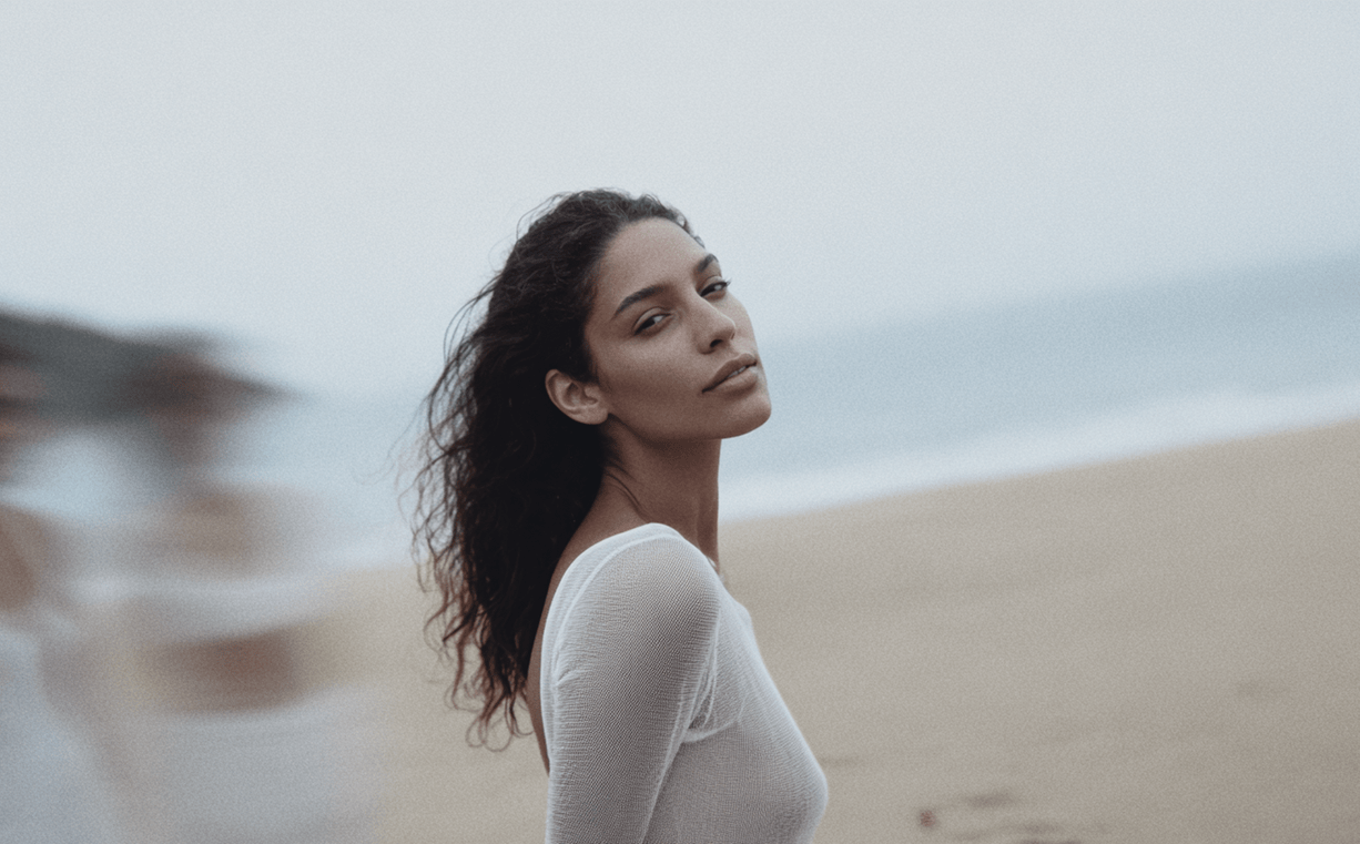 Woman standing on a beach with a blurred background