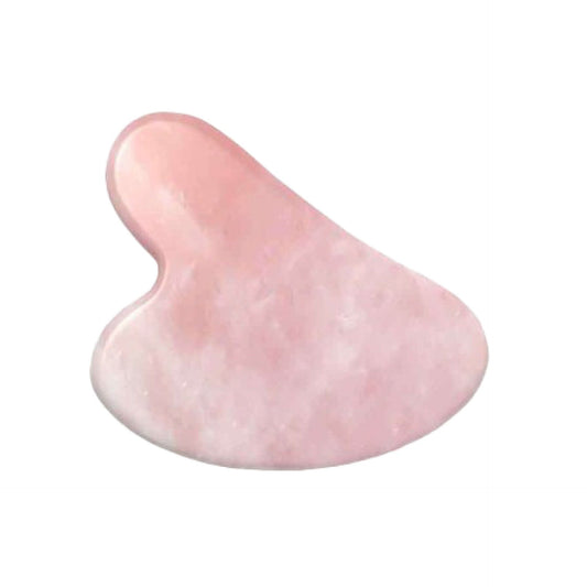 Pink gua sha tool on a white background