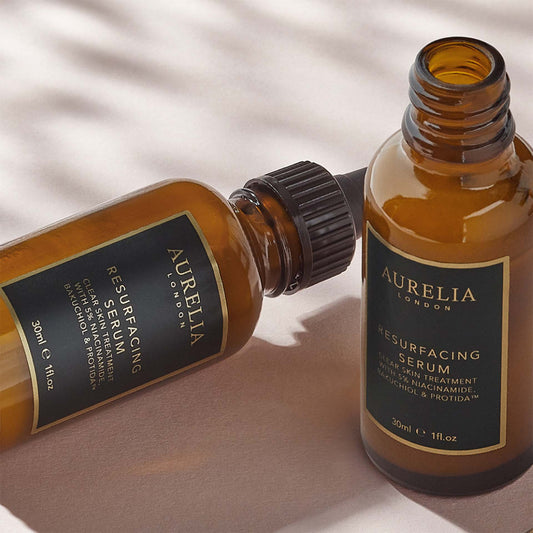 Two bottles of Aurelia London Resurfacing Serum on a light background